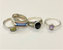 Four silver dress rings.