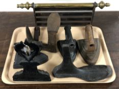 A tray of cast iron door stop, vintage irons, cobblers last,
