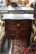 A continental inlaid walnut bombe style marble topped three drawer chest