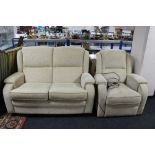 A two seater settee in oatmeal covering together with the matching electric reclining armchair