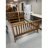 A contemporary 4'6" sleigh bed frame