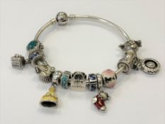 A Pandora silver bangle strung with charms.