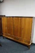 A mid century walnut sideboard fitted with four drawers