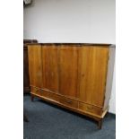 A mid century walnut sideboard fitted with four drawers