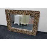 A rustic wooden framed overmantel mirror