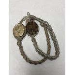 Two reproduction German military badges on braid