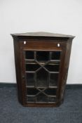 An Edwardian stained pine corner cabinet