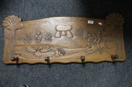 A Continental carved wooden coat rack