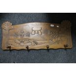 A Continental carved wooden coat rack