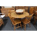 A contemporary oak kitchen table and four chairs