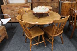 A contemporary oak kitchen table and four chairs