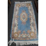 A blue fringed Chinese rug