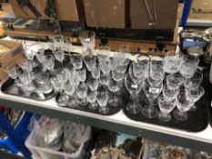 Three trays of twentieth century cut glass, wine glasses, champagne flutes,