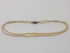 A 14 inch double strand of pearls on silver marcasite clasp