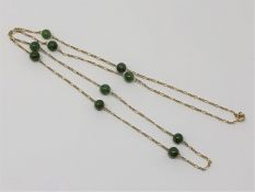 A jadeite and gold necklace