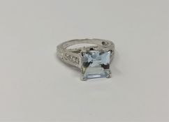 A white gold blue topaz and diamond ring,