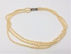 A nice 3-strand pearl necklace with white gold clasp set with diamonds