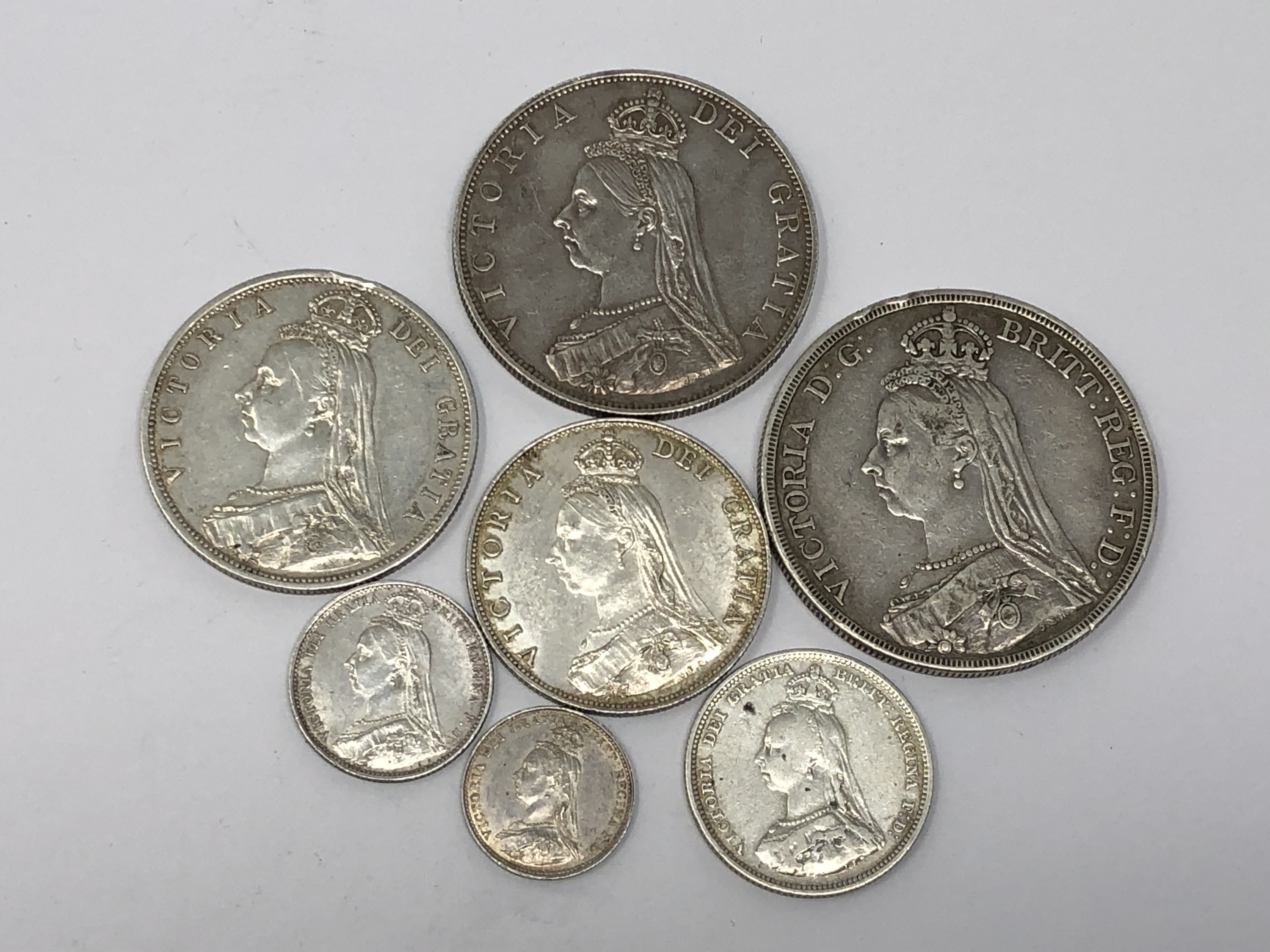 An 1887 Crown together with six other silver coins (7)
