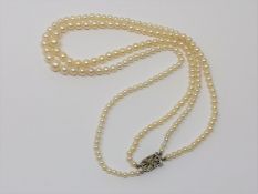 A good double strand of pearls on gold and diamond clasp