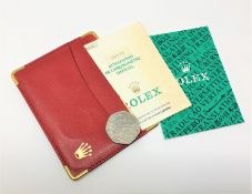 A red leather Rolex card wallet with Oyster booklet,