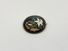 An oval pietra dura brooch in gold frame