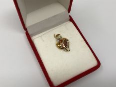 A 10ct gold mystic fire topaz and diamond set pendant