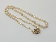 A good 20 inch strand of pearls on pearl mounted gold catch