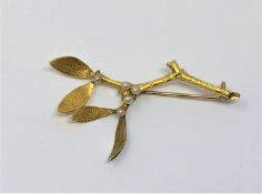 An 18ct gold pearl set brooch