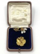 Two antique gold pearl set brooches.