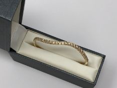 An 18ct gold bangle set with 30 diamonds, approximately 1.2ct, 8.8g.