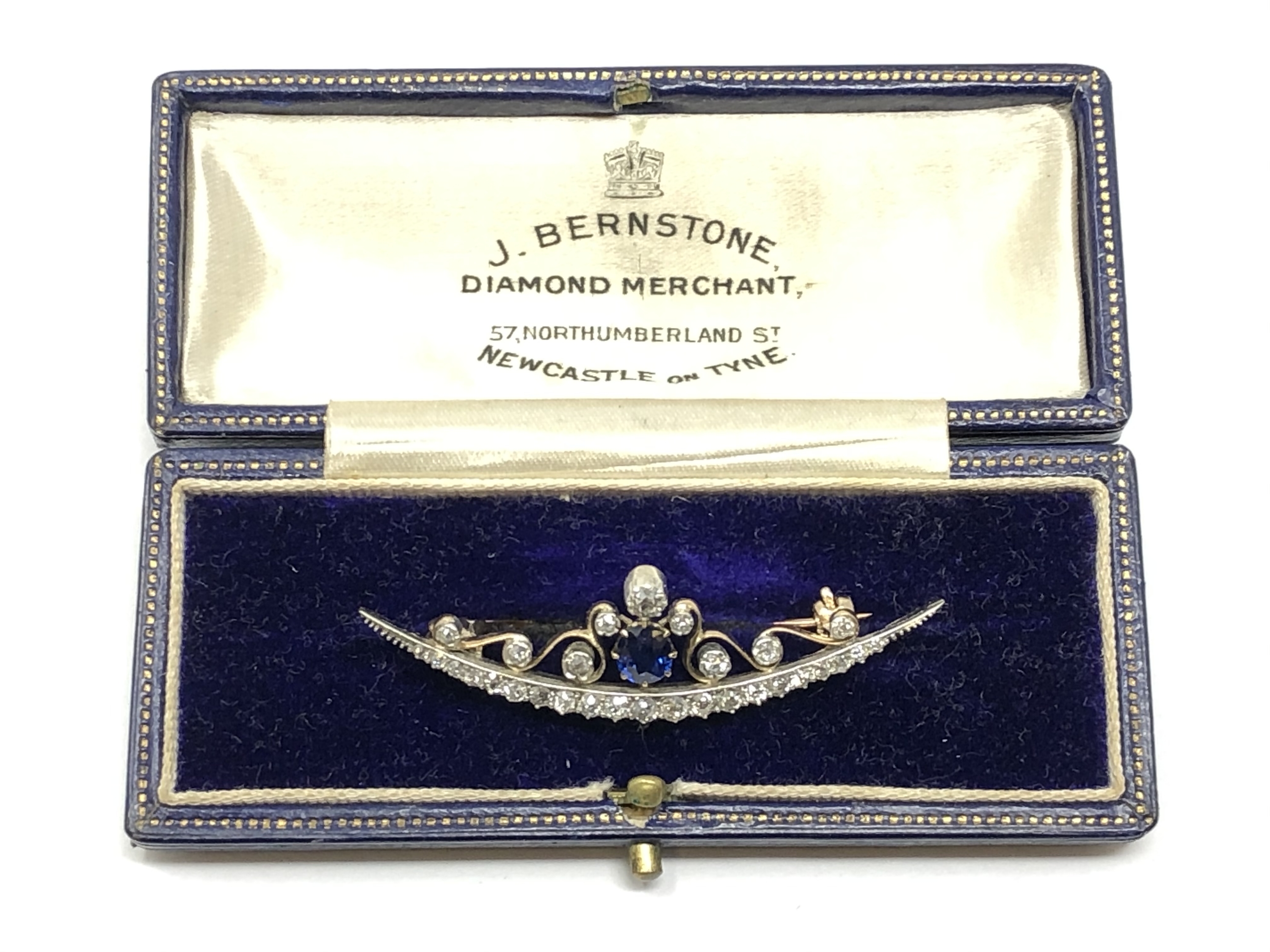 A superb quality antique diamond and sapphire crecent brooch, boxed.