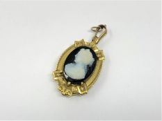 An antique gold agate cameo locket pendant