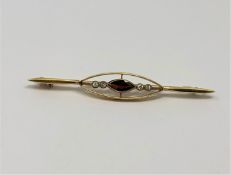An antique gold garnet and diamond brooch