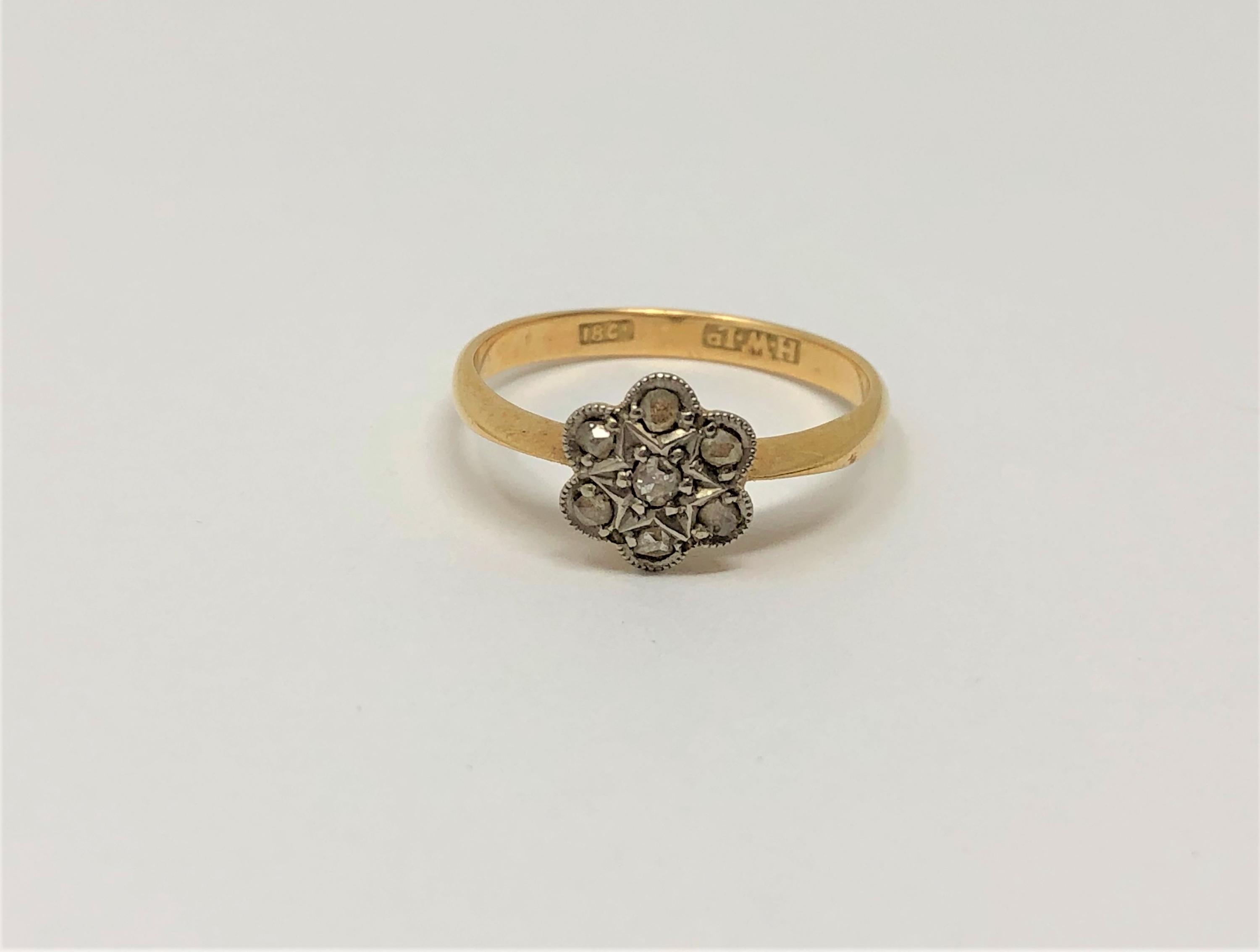An 18ct gold seven stone diamond cluster ring, size K, 2.1g.