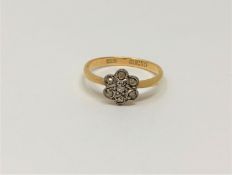 An 18ct gold seven stone diamond cluster ring, size K, 2.1g.