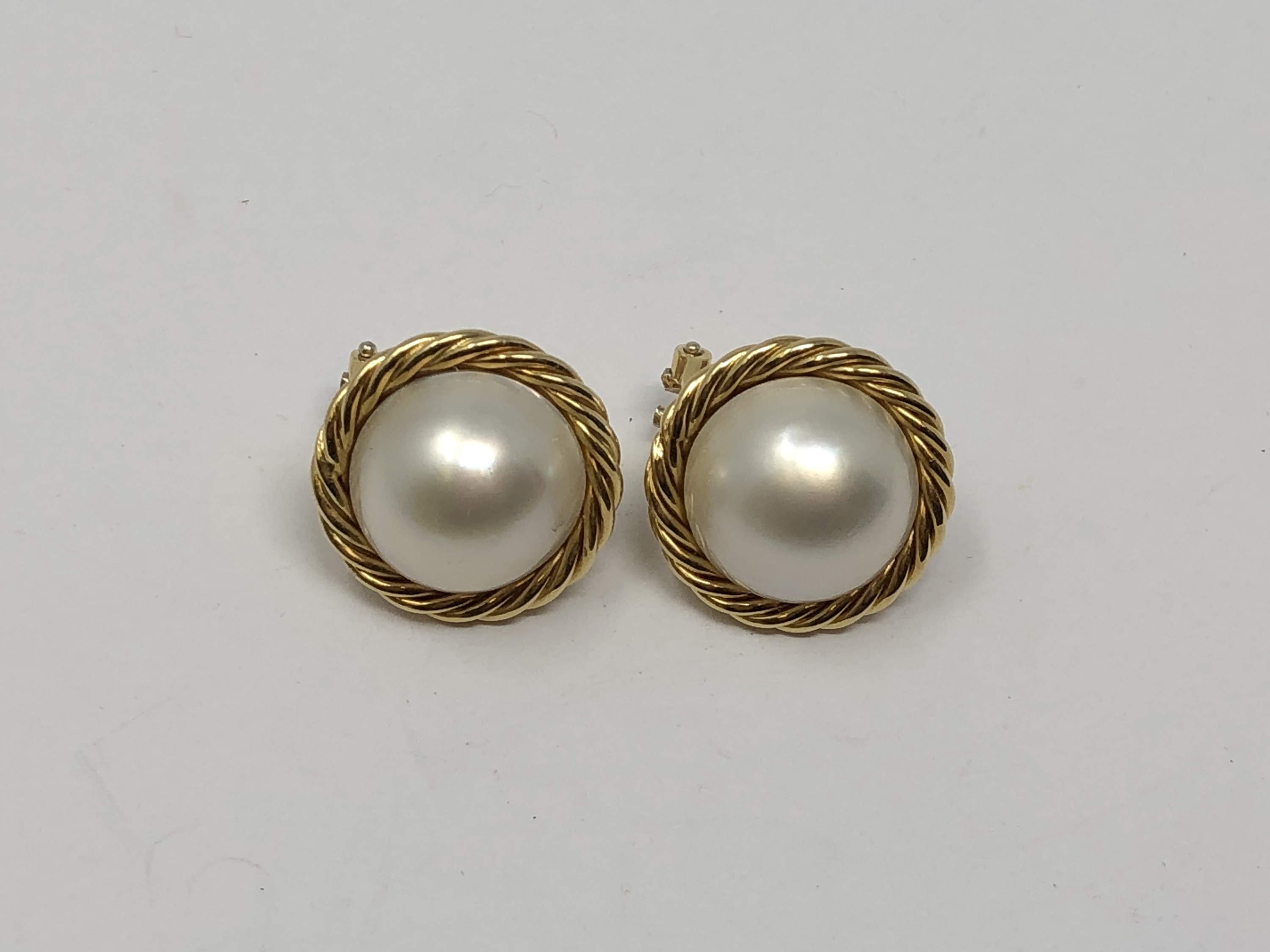 A pair of 18ct gold mabe pearl earrings.