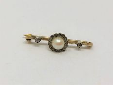 An antique yellow metal (tests gold) pearl and diamond brooch