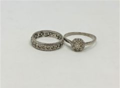 An 18ct white gold diamond cluster ring together with a white metal diamond eternity ring.