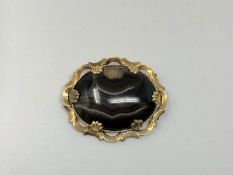 An antique gold and agate brooch