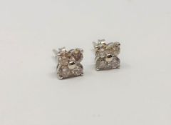 A pair of 18ct white gold diamond cluster earrings, approximately 1ct.