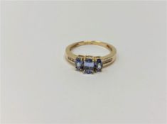 An 14ct yellow gold sapphire and diamond ring,