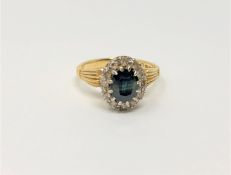 An 18ct gold sapphire and diamond cluster ring, size N, 5.4g.