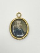 An early 18th century portrait miniature in high carat gold frame
