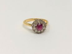 An 18ct gold ten stone diamond and ruby cluster ring, size M/N, 3.3g.