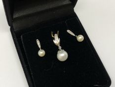 A white gold diamond and cultured pearl earring and pendant suite
