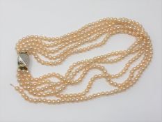 A good quality 15 inch five strand pearl necklace on two tone 14ct gold catch