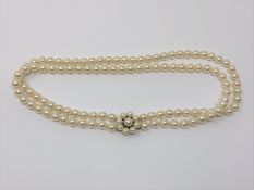 A good double 16 inch strand of pearls with pearl and gold catch