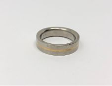 A gent's gold and titanium band ring,