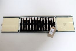 A set of silver twelve pickle forks with enamelled card terminals