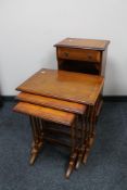 A reproduction yew wood telephone stand together with a nest of tables
